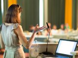 Female speaker at Business Conference and Presentation. Audience at the conference hall. Business and Entrepreneurship. Business woman. Horizontal composition.